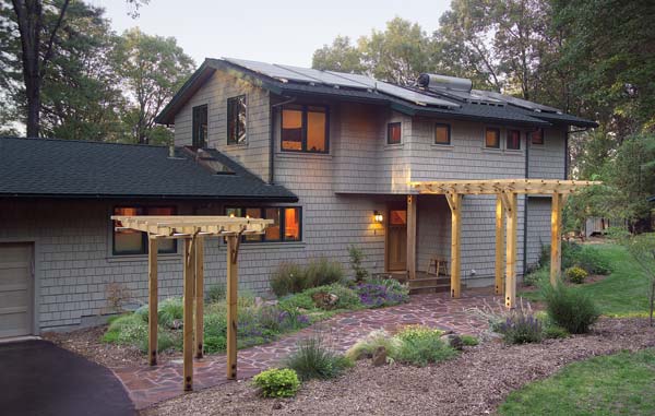 
The roof has a radiant barrier, a reflective layer stapled to the underside of the sheathing to reduce exterior heat conduction. Exterior shingles are covered with a low-VOC stain.
